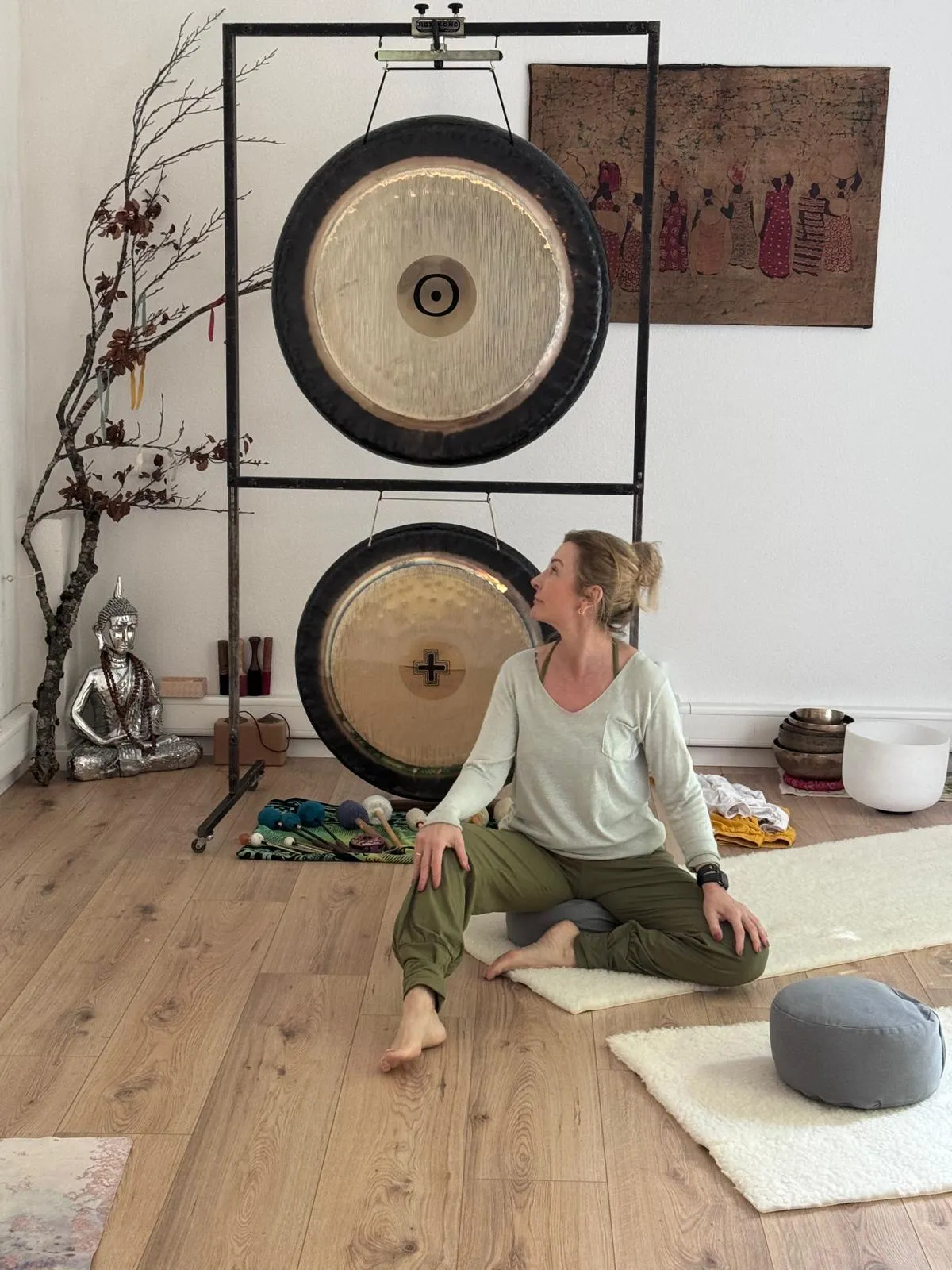 Seated beside the two large gongs in the studio