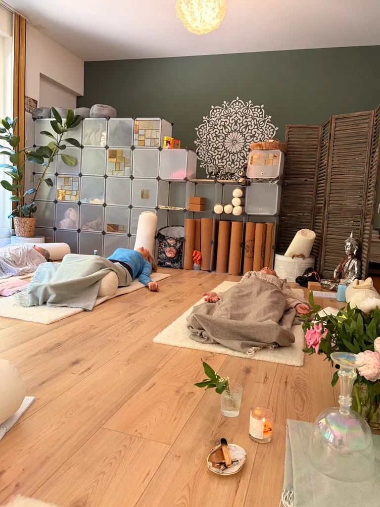 A restorative session in progress, guests resting under warm blankets